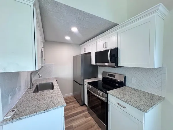 a bathroom with a sink toilet and mirror