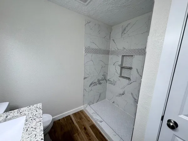 a bathroom with a toilet sink and mirror