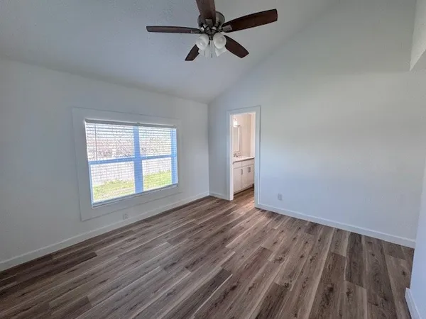 a view of backyard with brick wall and two chair