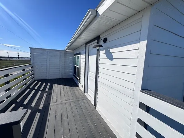 a view of a kitchen with wooden floor and a ceiling fan