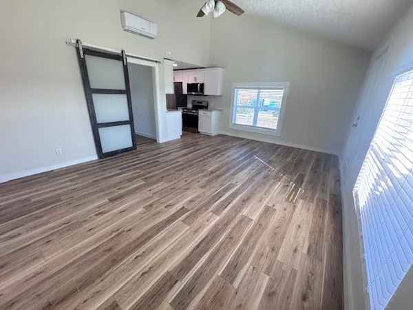 a kitchen with a sink wooden floor and a window