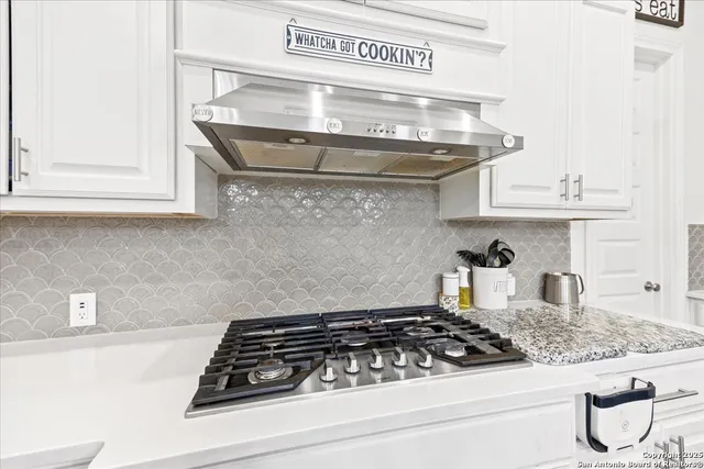 a close view of a stove a microwave and cabinets