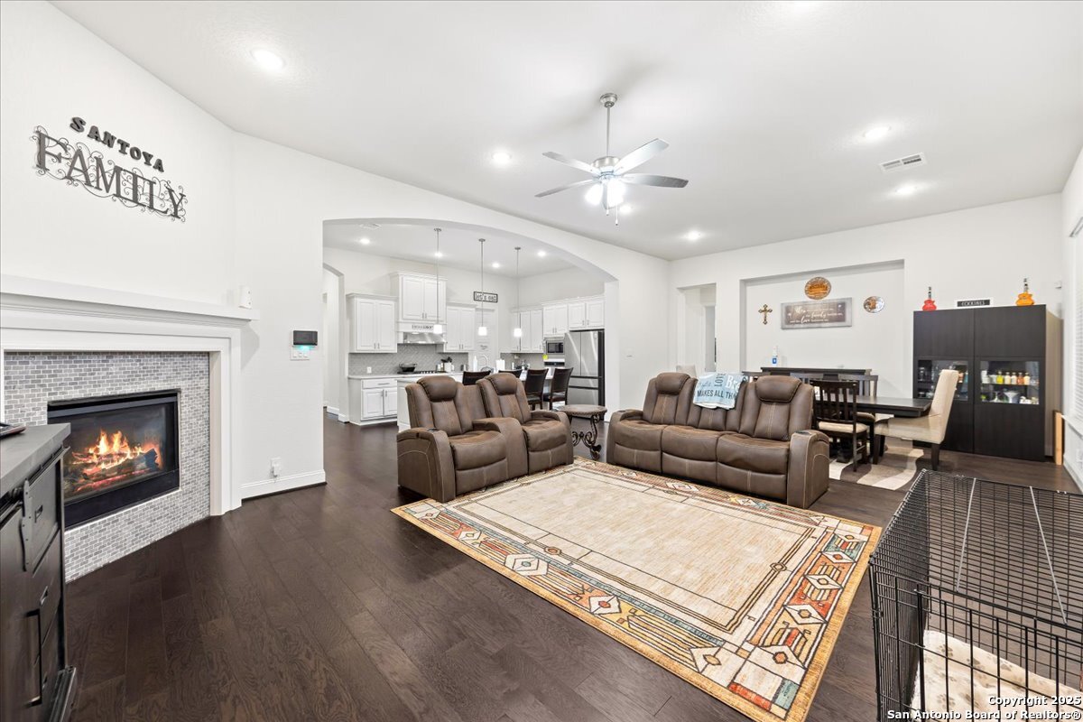 6957 Hallie Loop Schertz, TX 78154 - Photo 16 of 51 a living room with furniture fireplace and wooden floor