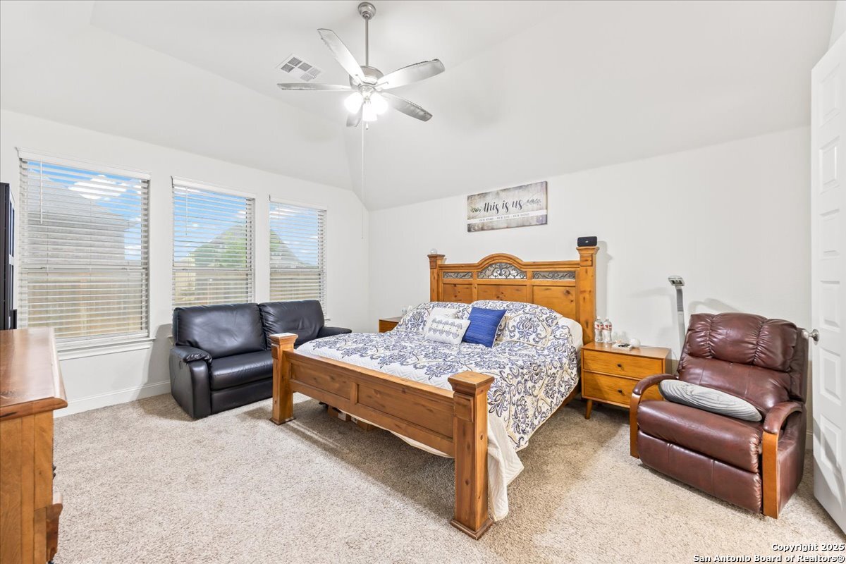 6957 Hallie Loop Schertz, TX 78154 - Photo 22 of 51 a bedroom with a bed and furniture
