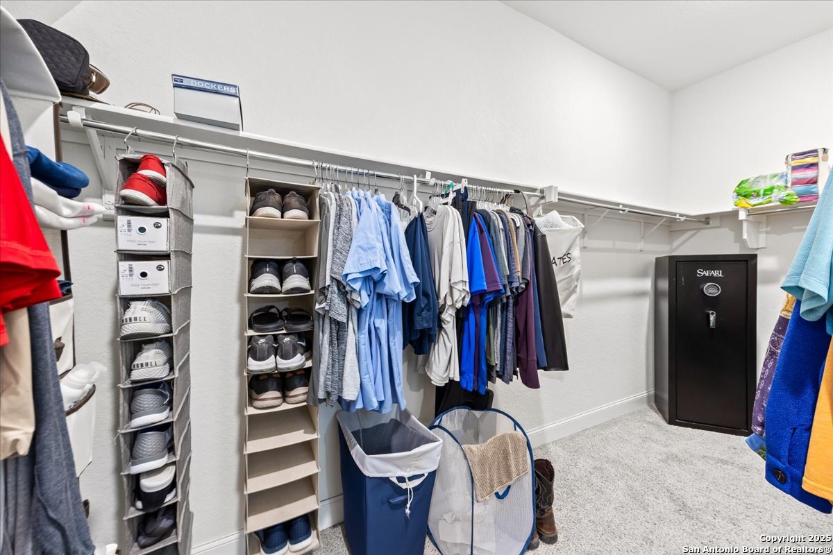 6957 Hallie Loop Schertz, TX 78154 - Photo 28 of 51 a view of walk in closet with clothes and shoes