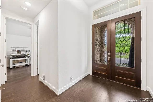 a view of a workspace with furniture and windows