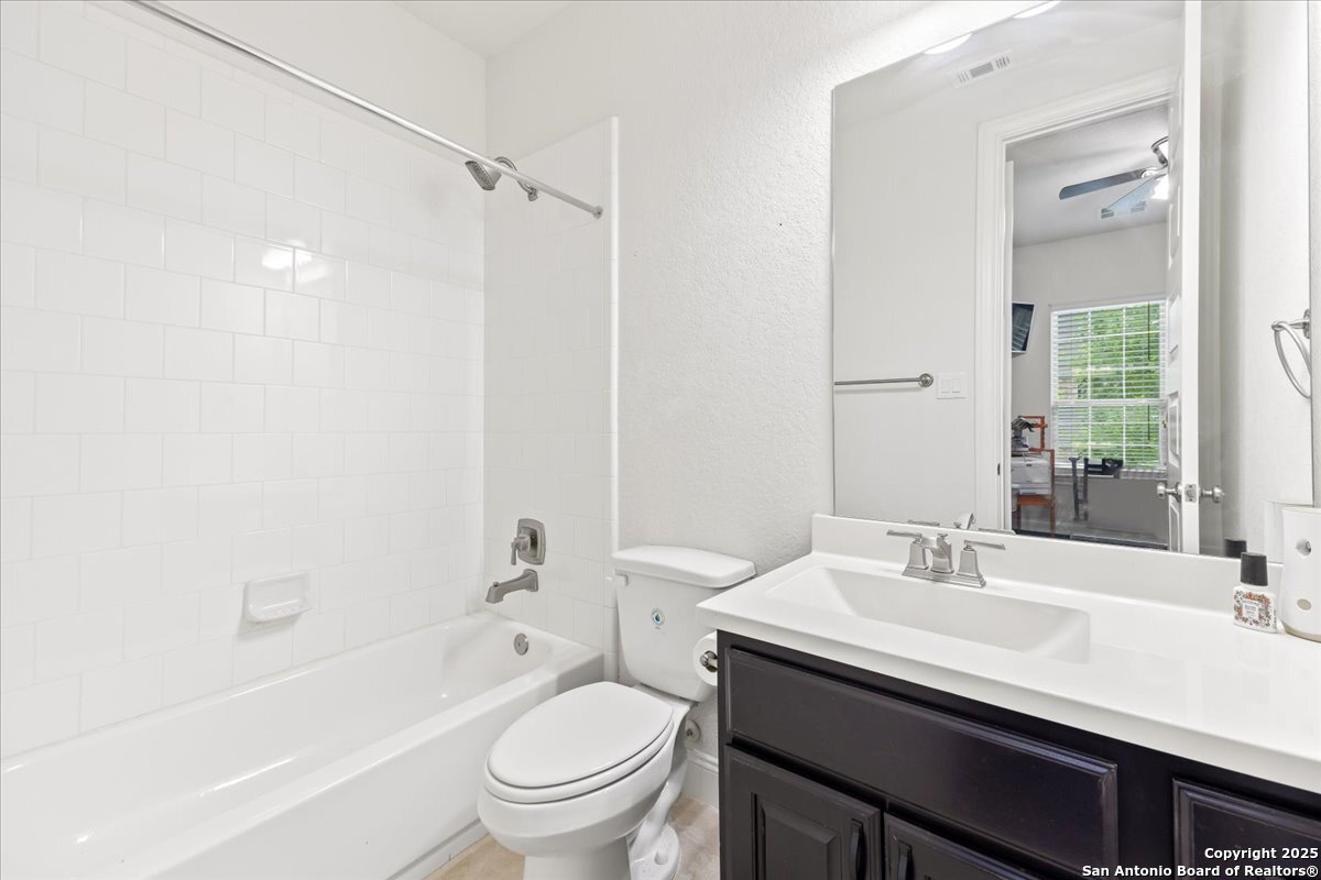 6957 Hallie Loop Schertz, TX 78154 - Photo 31 of 51 a bathroom with a sink toilet vanity and shower