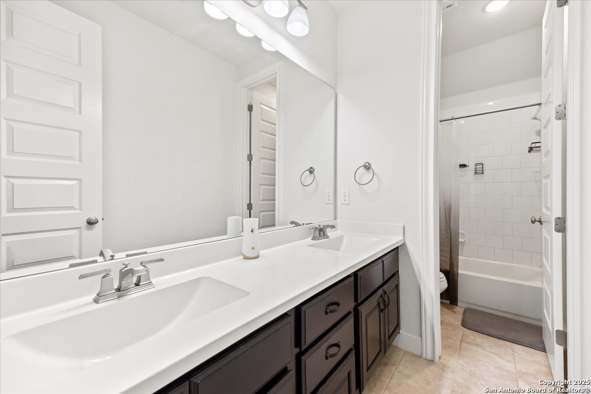 6957 Hallie Loop Schertz, TX 78154 - Photo 33 of 51 a bathroom with a double vanity sink mirror and double