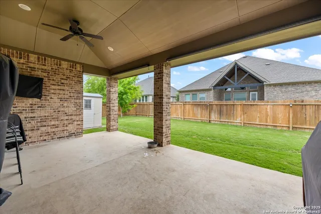 a front view of a house with outdoor seating and a yard