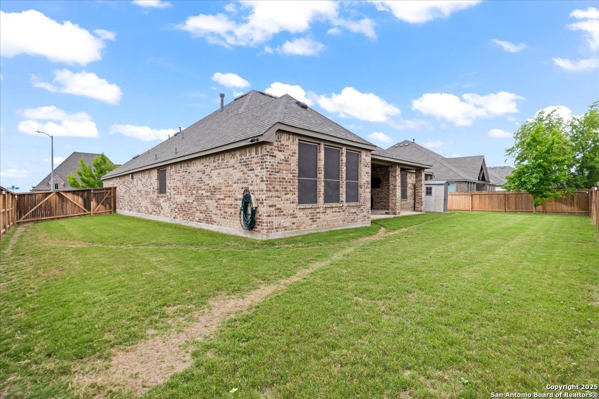 6957 Hallie Loop Schertz, TX 78154 - Photo 40 of 51 a view of a house with a backyard