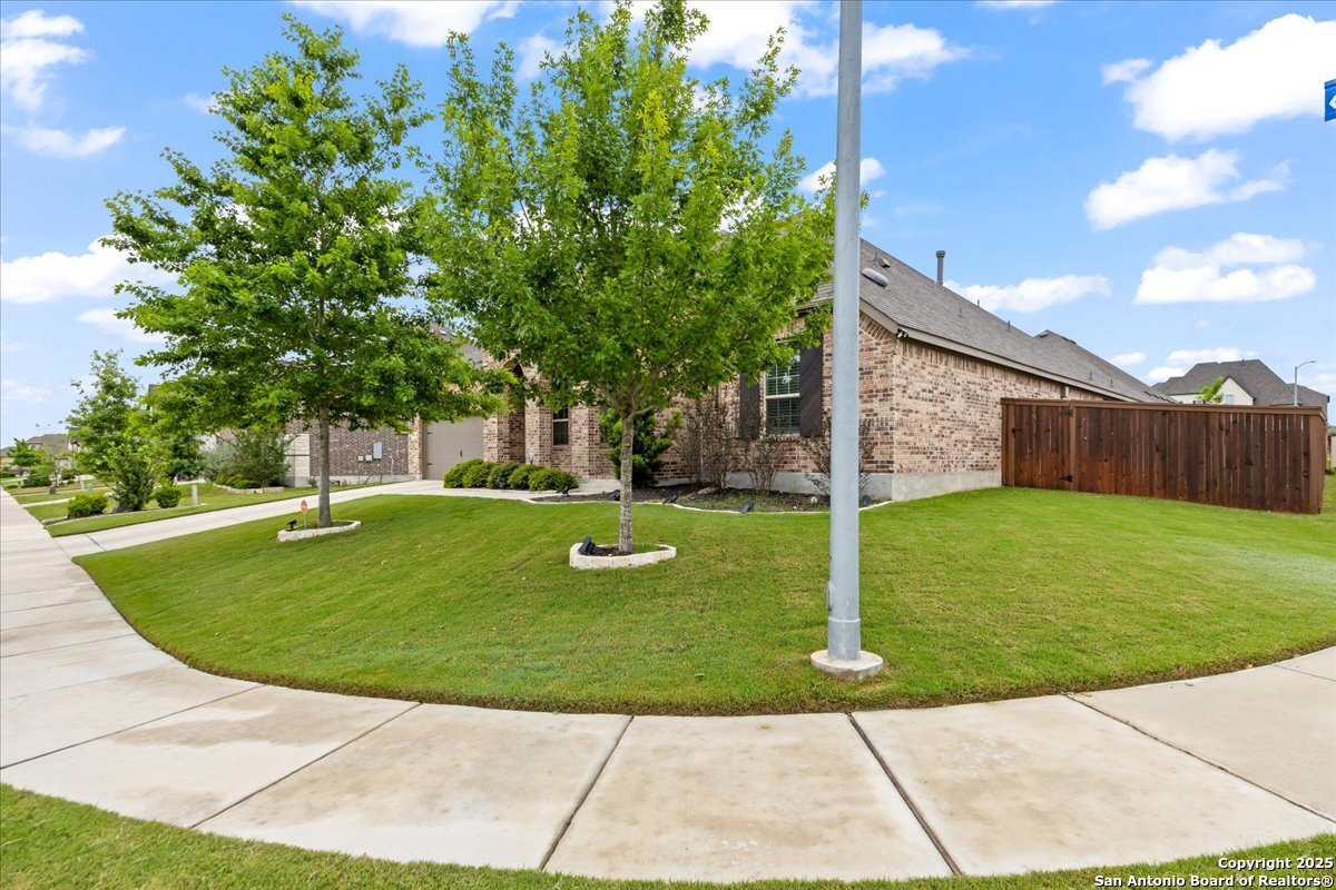 6957 Hallie Loop Schertz, TX 78154 - Photo 44 of 51 a view of a house with a backyard