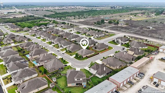 an aerial view of residential houses with outdoor space