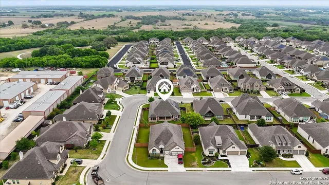 an aerial view of residential houses with outdoor space