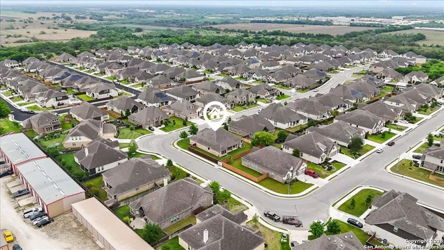 an aerial view of residential houses with outdoor space