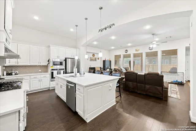 a large white kitchen with a large window