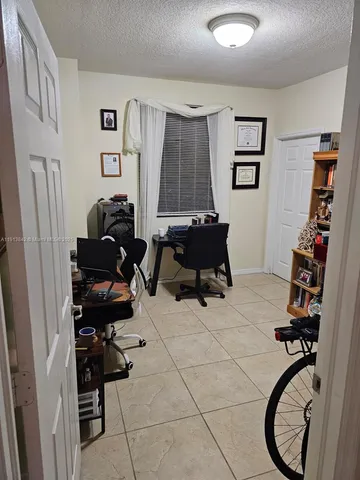 a room with gym equipment and a window