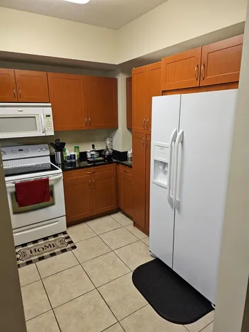 a kitchen with stainless steel appliances a refrigerator sink and cabinets