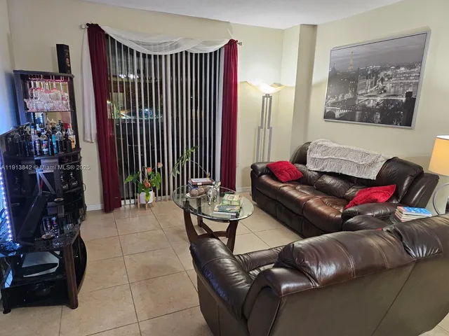 a living room with furniture and a lamp