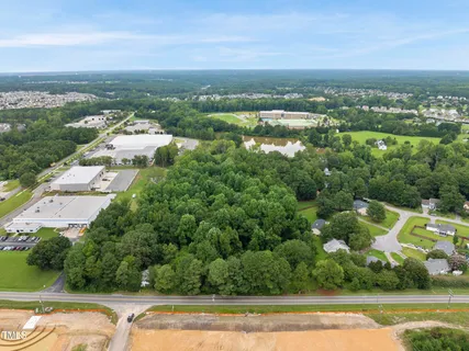an aerial view of residential houses with outdoor space and swimming pool