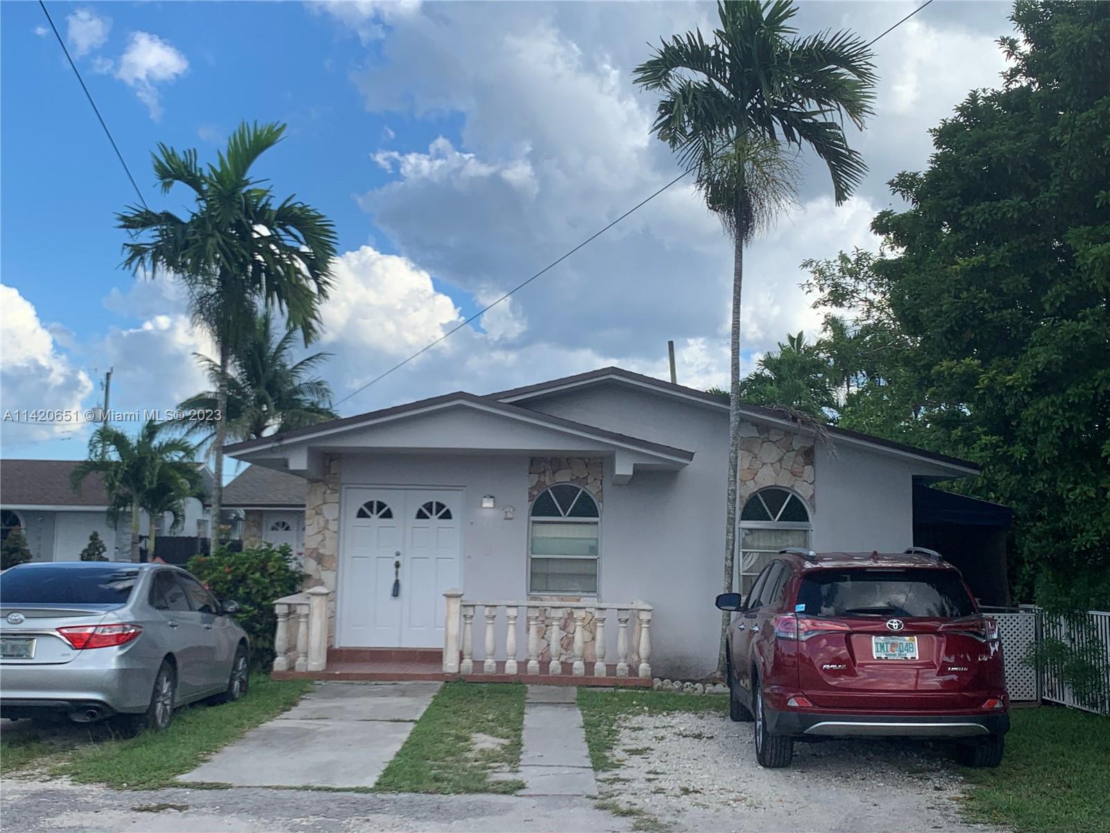 7442 Southwest 22nd Street, Unit 7442 Miami, FL 33155 - Photo 1 of 11 a front view of a house with a garden