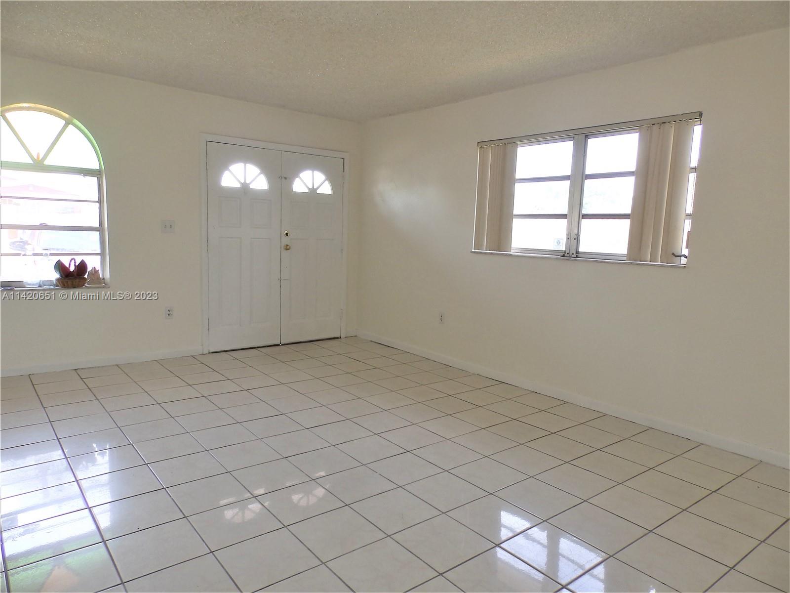 7442 Southwest 22nd Street, Unit 7442 Miami, FL 33155 - Photo 3 of 11 an empty room with windows