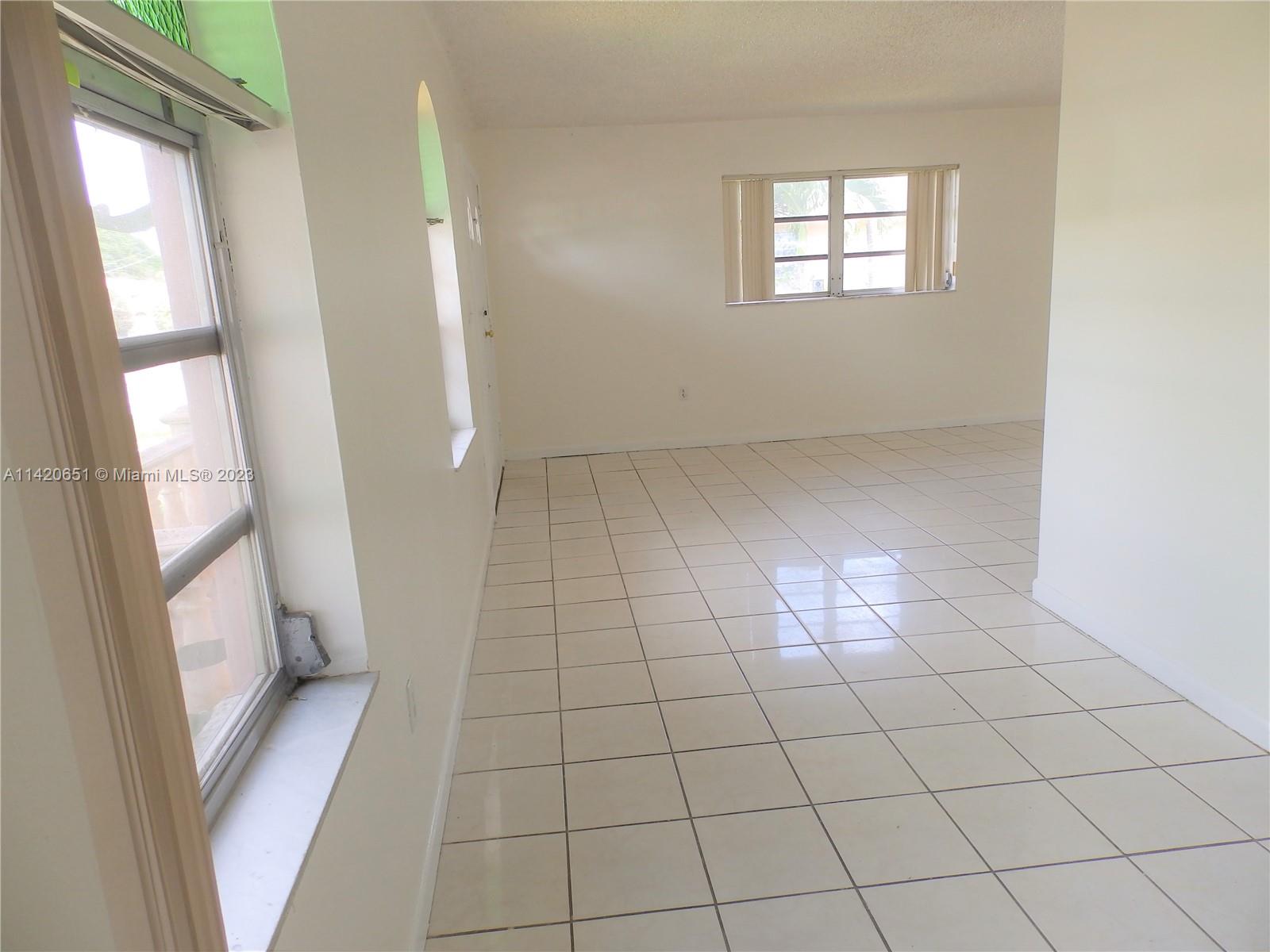 7442 Southwest 22nd Street, Unit 7442 Miami, FL 33155 - Photo 5 of 11 a view of empty room with windows