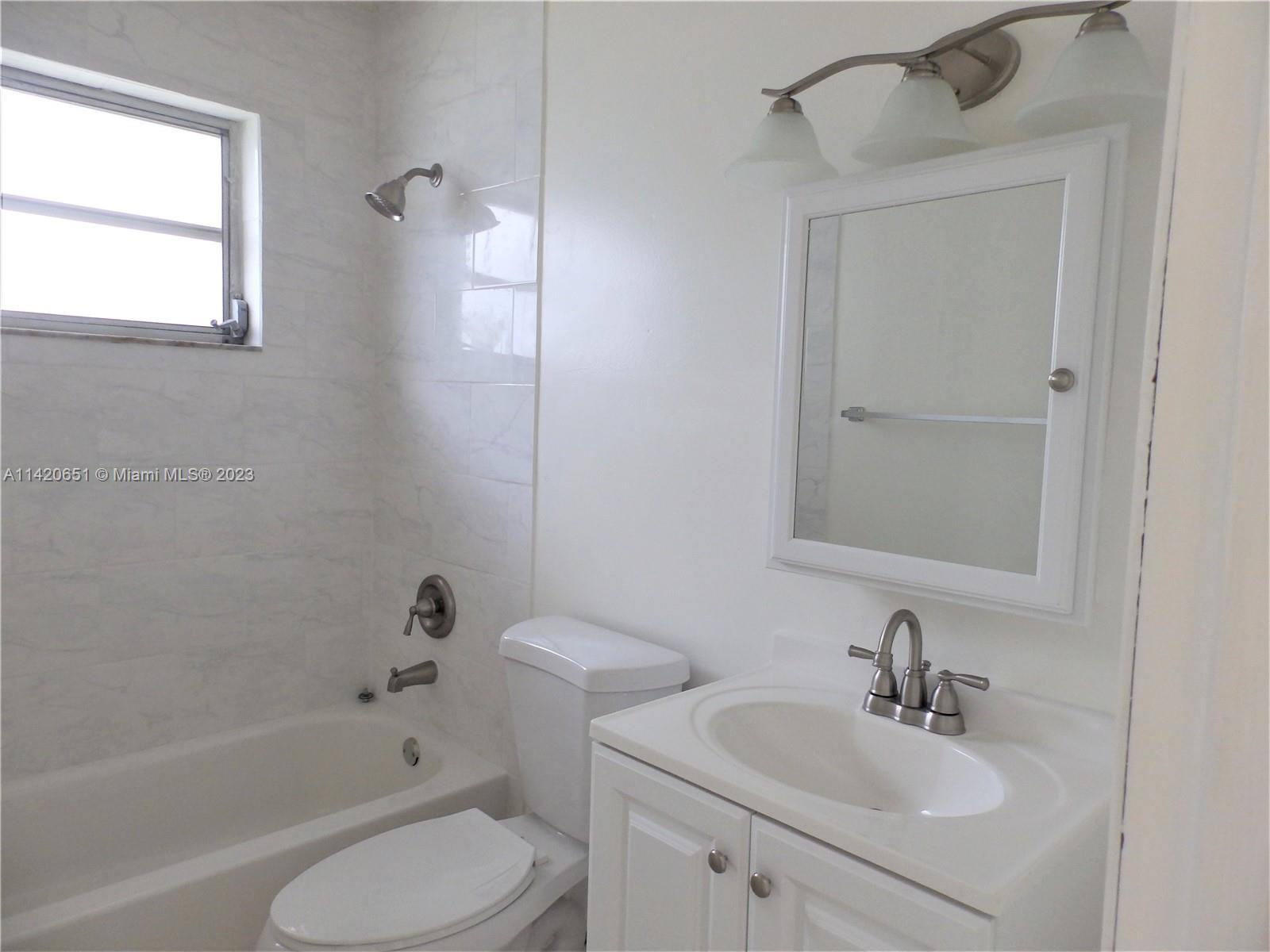 7442 Southwest 22nd Street, Unit 7442 Miami, FL 33155 - Photo 8 of 11 a bathroom with a sink toilet a bathtub and a vanity
