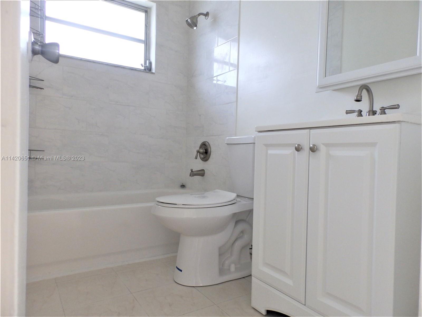 7442 Southwest 22nd Street, Unit 7442 Miami, FL 33155 - Photo 9 of 11 a bathroom with a sink a toilet and shower