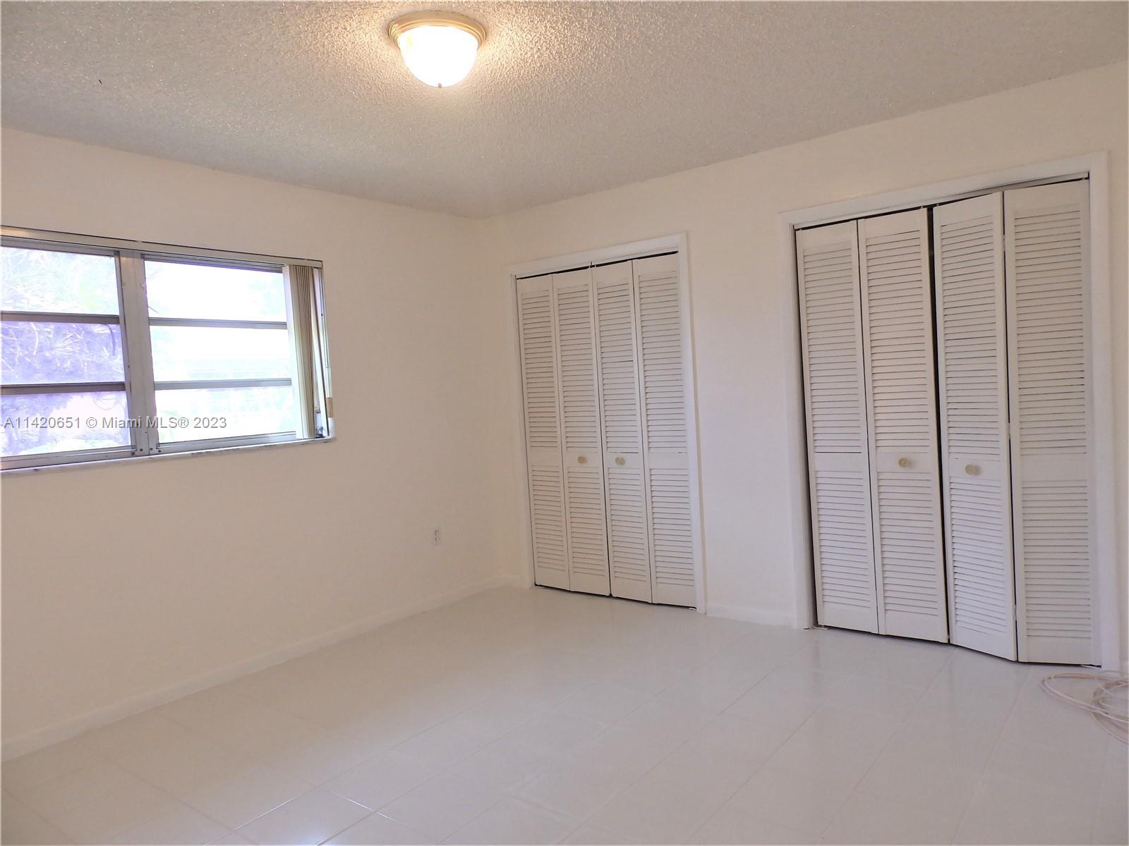 7442 Southwest 22nd Street, Unit 7442 Miami, FL 33155 - Photo 10 of 11 an empty room with windows
