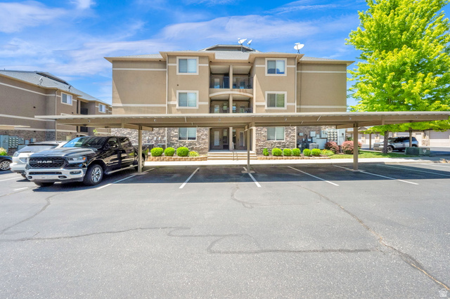 909 South Main Street, Unit G Layton, UT 84041 - Photo 23 of 25 Multi-story stucco exterior featuring stone accents and a covered carport
