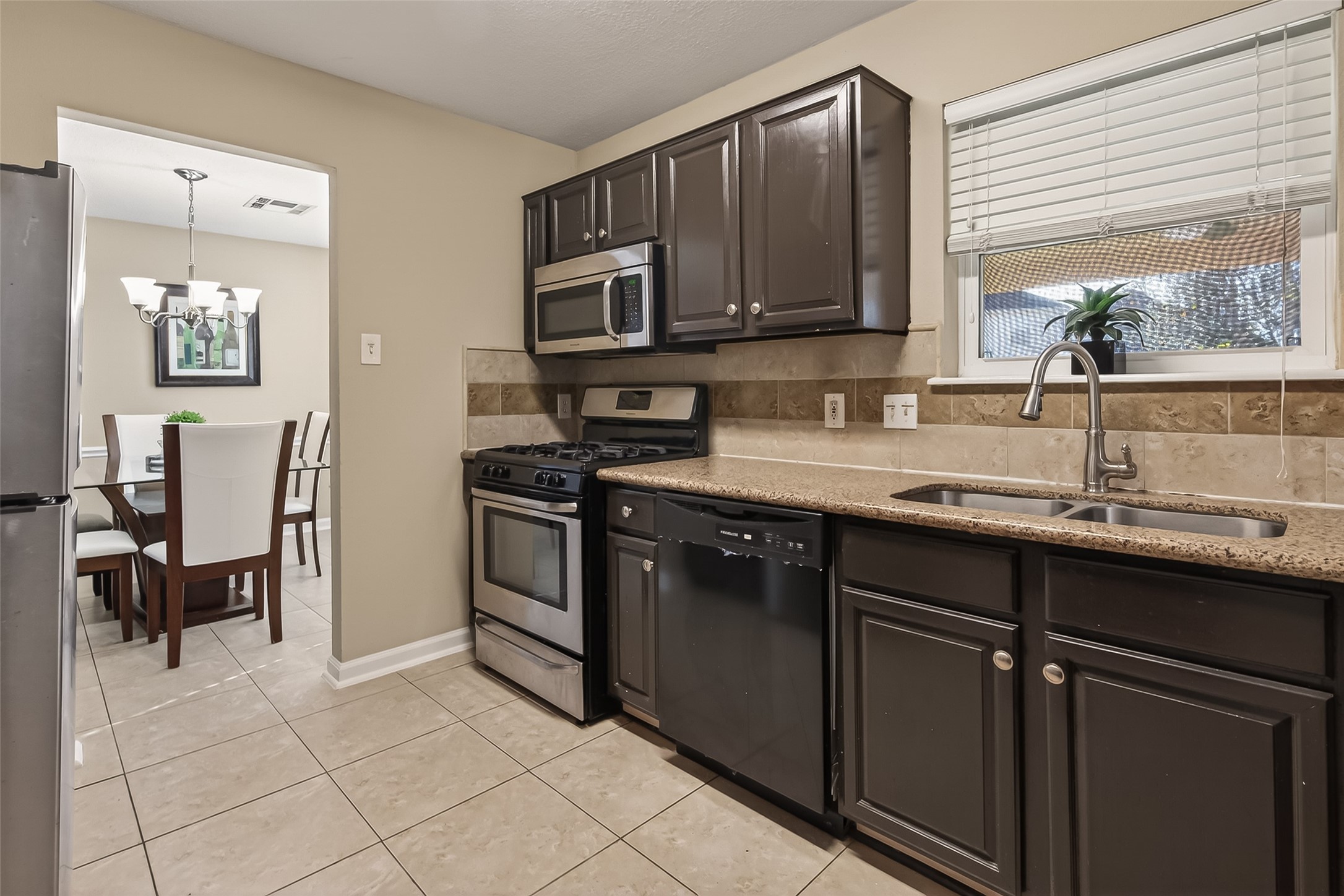 618 Bold Ruler Drive Stafford, TX 77477 - Photo 11 of 35 a kitchen with stainless steel appliances granite countertop a sink stove and microwave