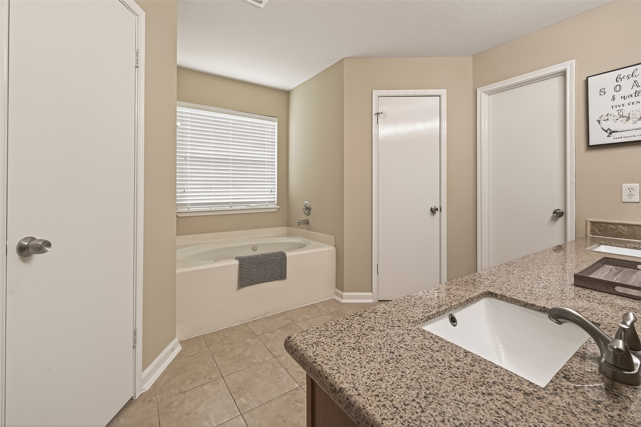 618 Bold Ruler Drive Stafford, TX 77477 - Photo 28 of 35 a spacious bathroom with a granite countertop sink and a mirror