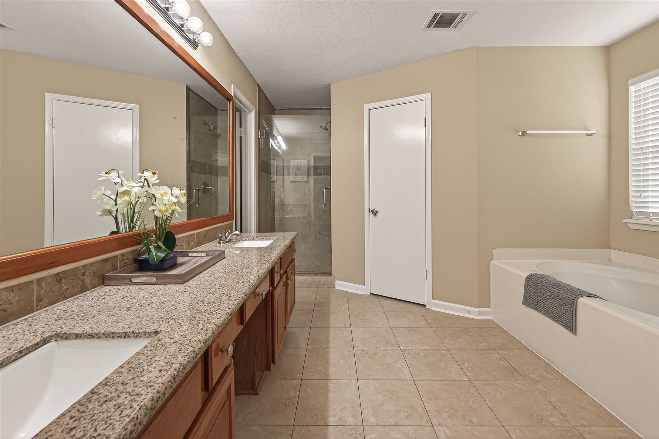 618 Bold Ruler Drive Stafford, TX 77477 - Photo 31 of 35 a bathroom with a granite countertop sink a mirror and a shower