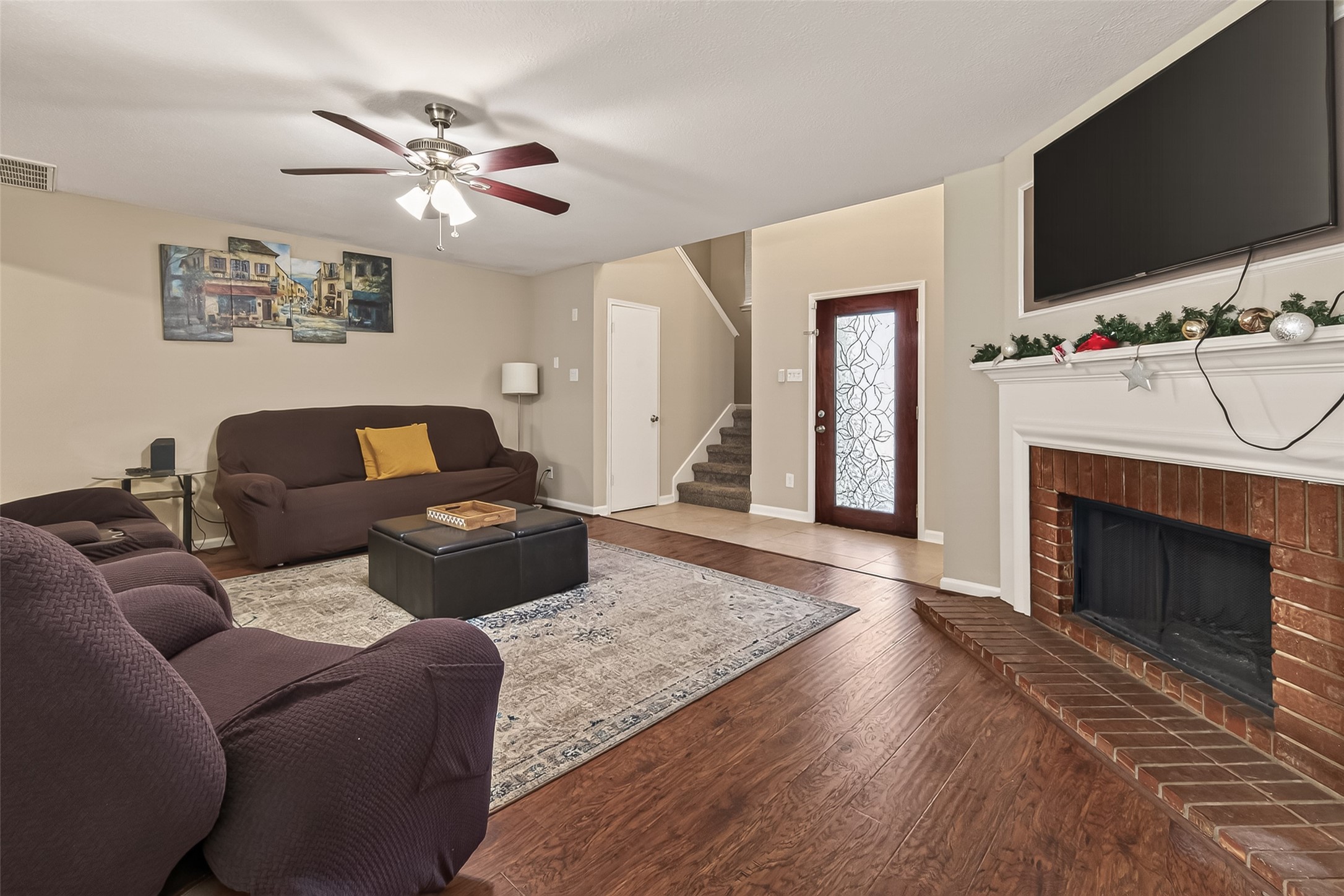 618 Bold Ruler Drive Stafford, TX 77477 - Photo 7 of 35 a living room with furniture a flat screen tv and a fireplace
