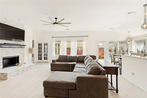 a living room with furniture and a view of kitchen