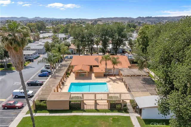 an aerial view of residential houses with outdoor space and parking
