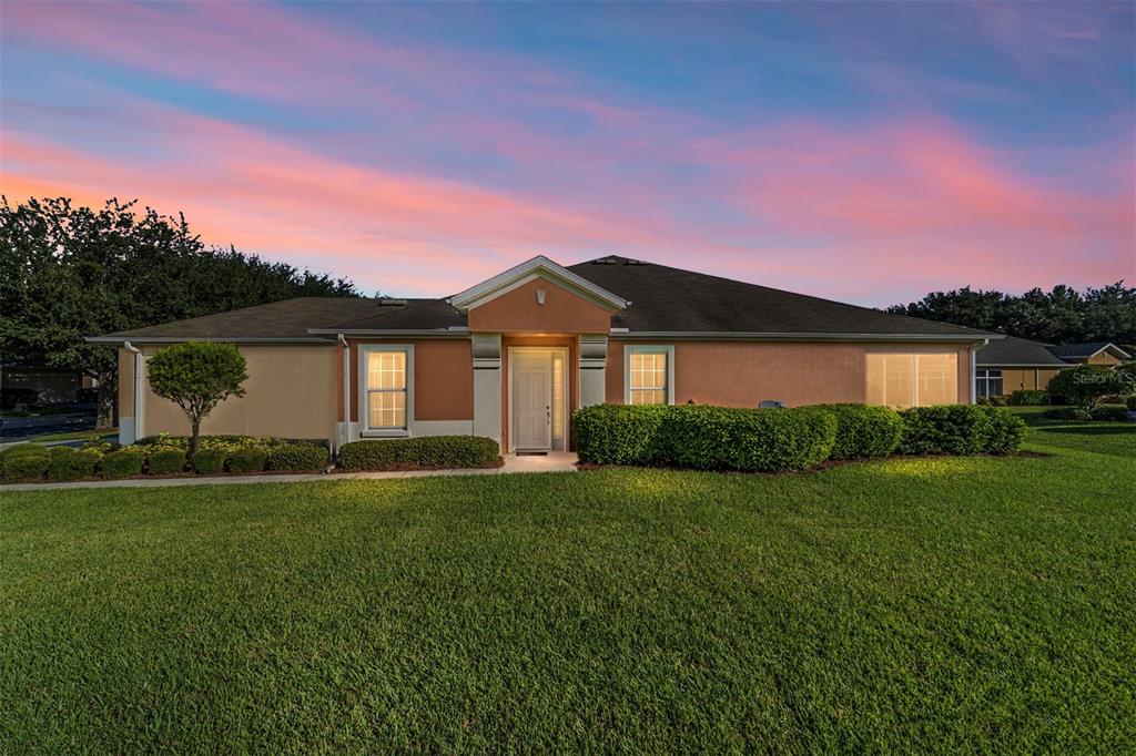 7153 Southwest 93rd Avenue Ocala, FL 34481 - Photo 1 of 61 a front view of a house with a garden