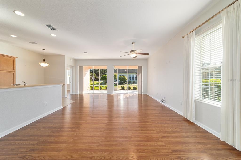 7153 Southwest 93rd Avenue Ocala, FL 34481 - Photo 12 of 61 a view of an empty room with wooden floor and a window