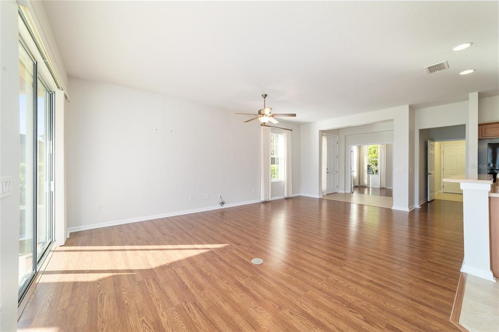 7153 Southwest 93rd Avenue Ocala, FL 34481 - Photo 16 of 61 an empty room with wooden floor and windows