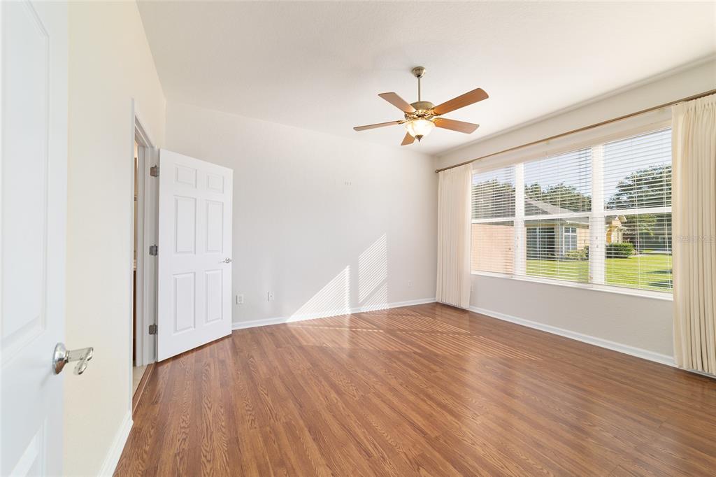 7153 Southwest 93rd Avenue Ocala, FL 34481 - Photo 26 of 61 a view of empty room with wooden floor and fan