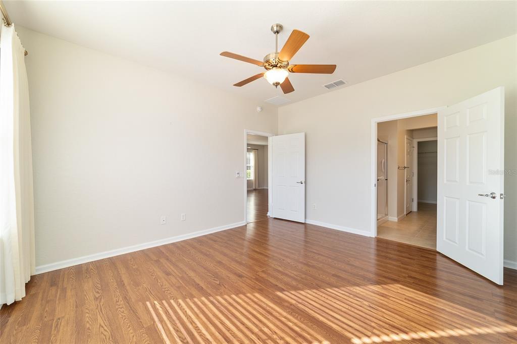 7153 Southwest 93rd Avenue Ocala, FL 34481 - Photo 27 of 61 a view of empty room with wooden floor and ceiling fan