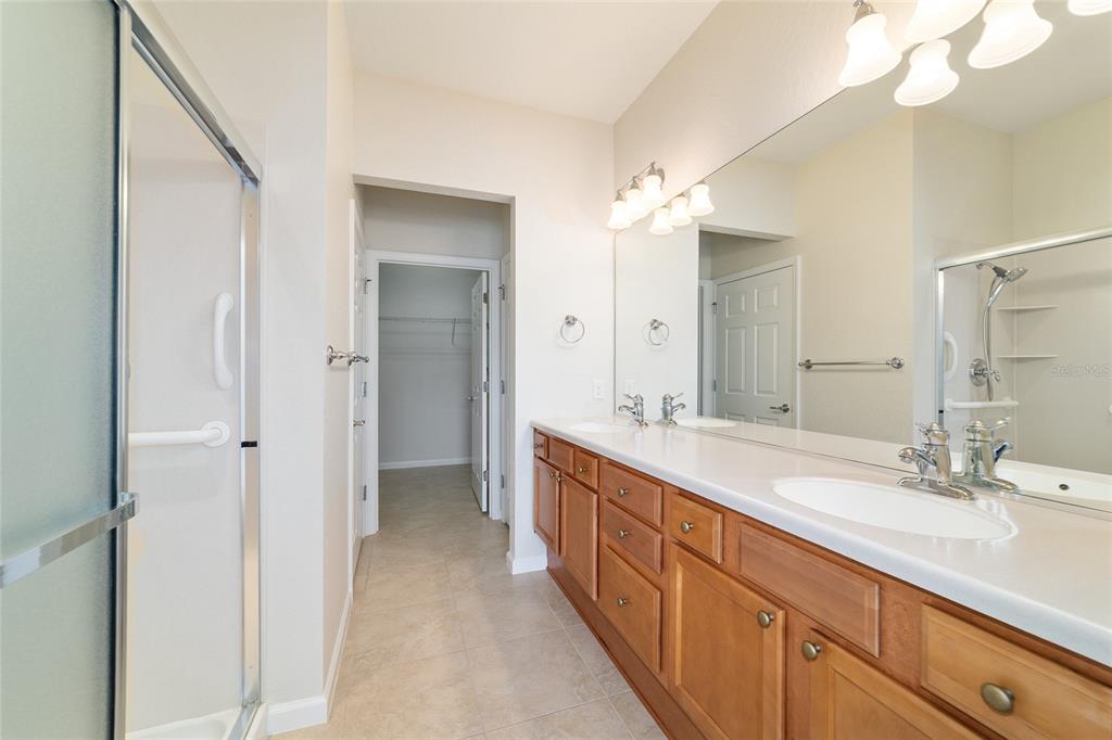 7153 Southwest 93rd Avenue Ocala, FL 34481 - Photo 29 of 61 a spacious bathroom with a double vanity sink mirror and double