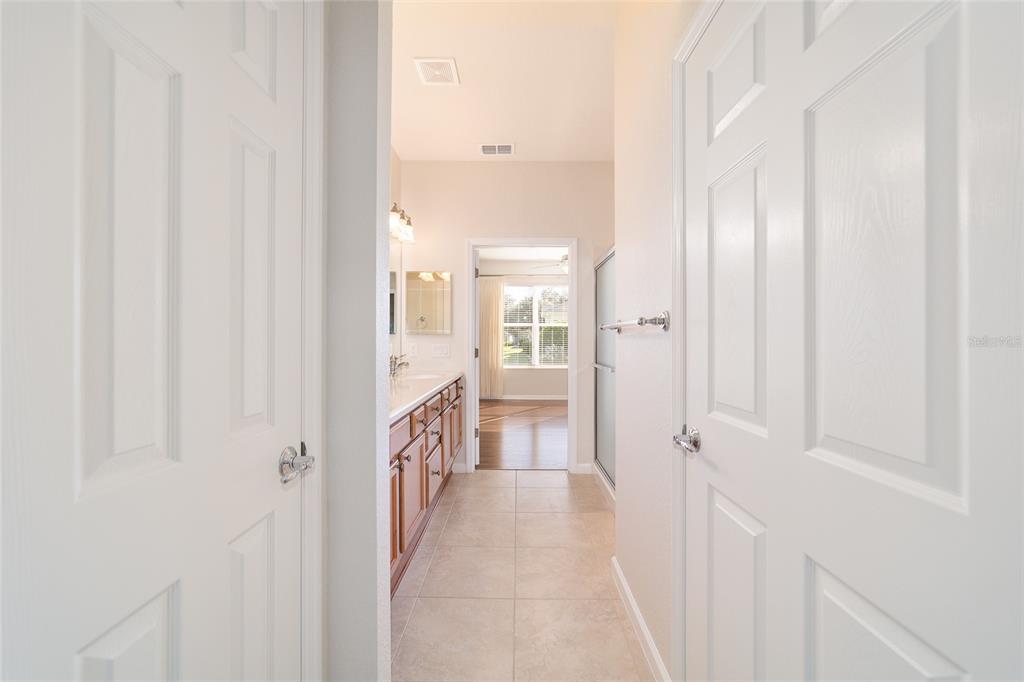 7153 Southwest 93rd Avenue Ocala, FL 34481 - Photo 30 of 61 a view of a hallway with a livingroom and a bathroom with a sink