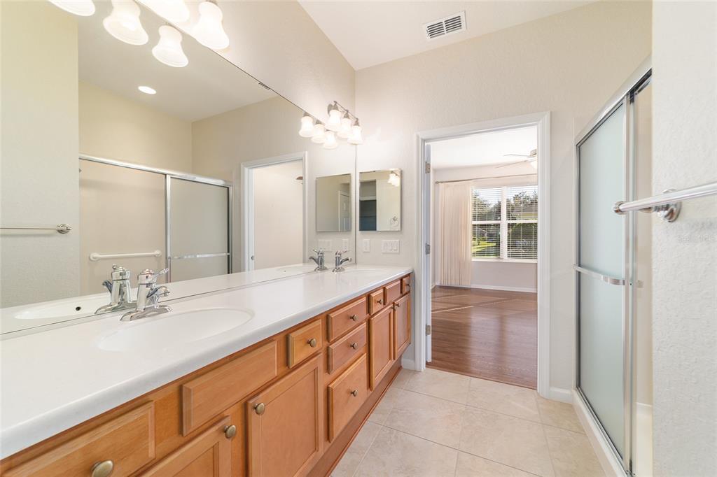 7153 Southwest 93rd Avenue Ocala, FL 34481 - Photo 31 of 61 a spacious bathroom with a double vanity sink mirror and next to a window