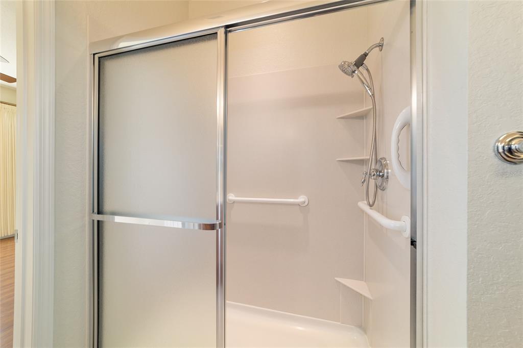 7153 Southwest 93rd Avenue Ocala, FL 34481 - Photo 32 of 61 a bathroom with a glass shower door