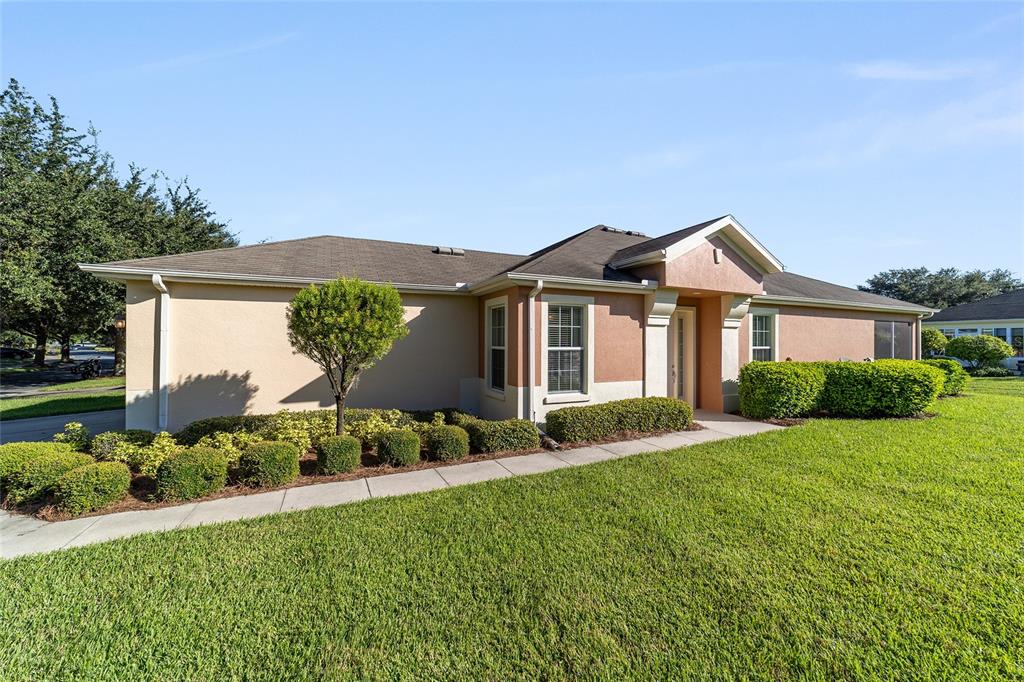 7153 Southwest 93rd Avenue Ocala, FL 34481 - Photo 4 of 61 a front view of a house with a garden