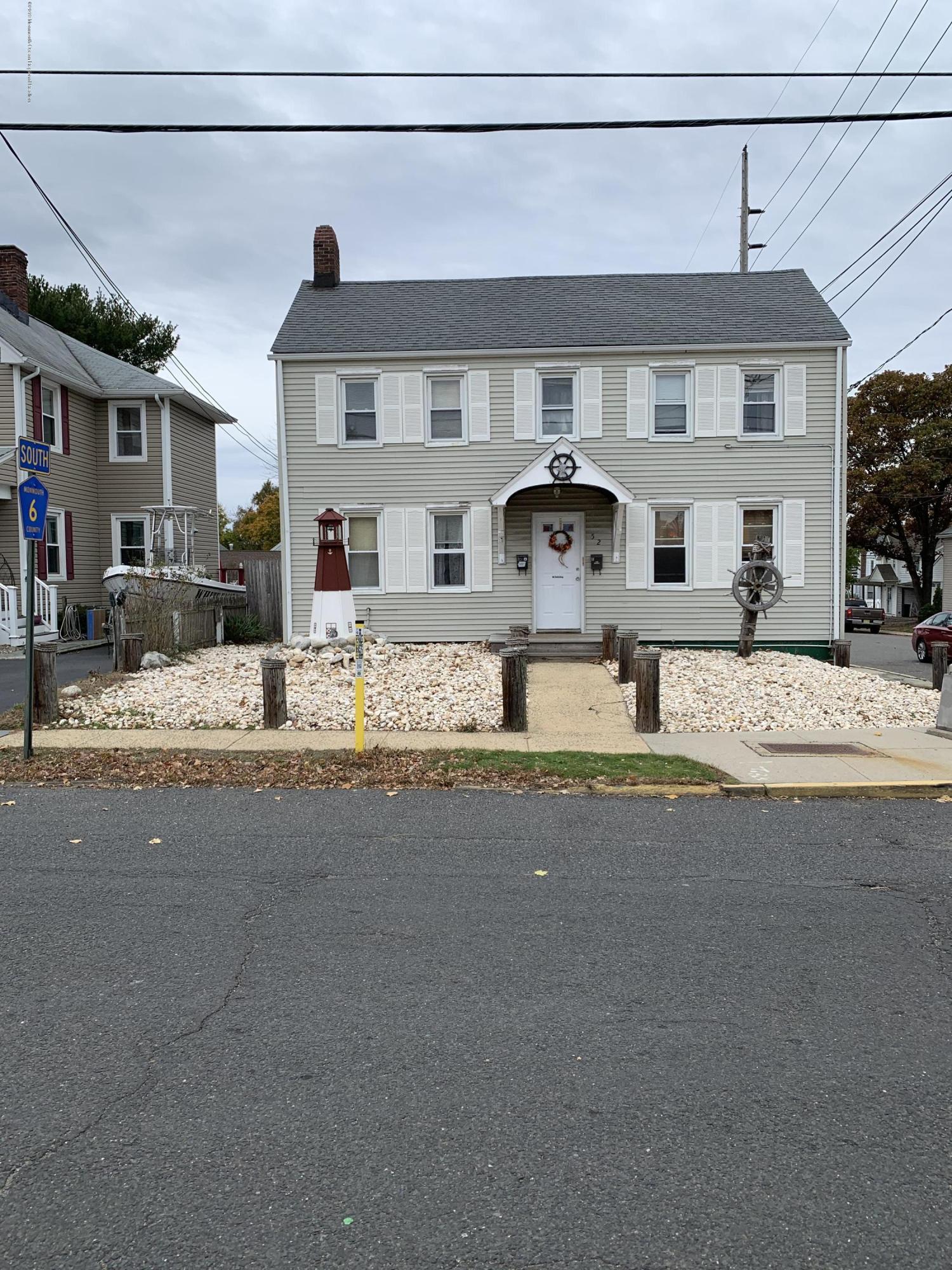 52 Broadway Keyport, NJ 07735 - Photo 2 of 3 a front view of a house with yard and parking