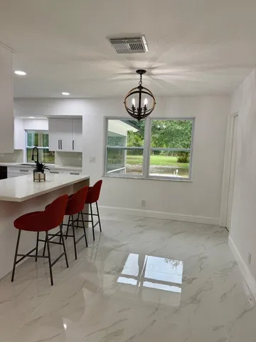 a kitchen with stainless steel appliances a sink and a refrigerator