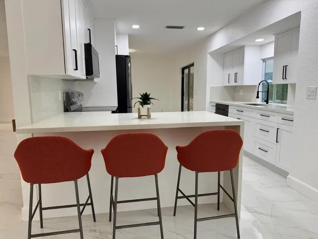 a kitchen with granite countertop cabinets and appliances