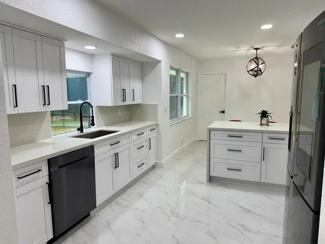 a kitchen with stainless steel appliances a refrigerator a stove and a microwave